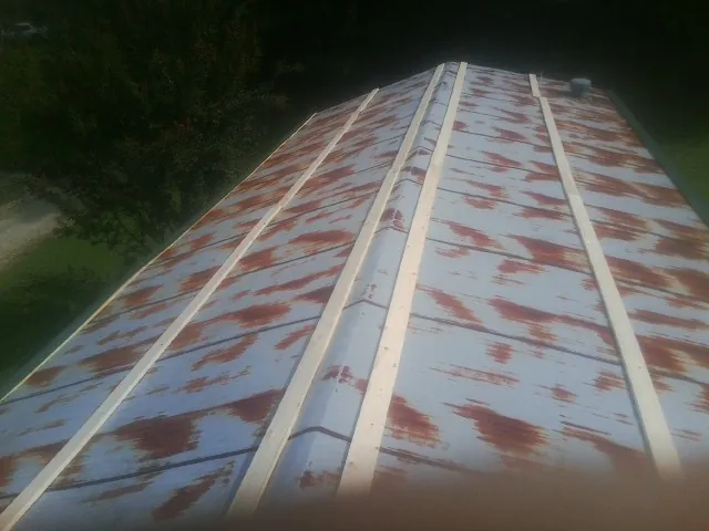Rusted metal roof panels with new wood purlins before replacement — Storm Damage Roof Repair in Blenheim by Roofing Brothers