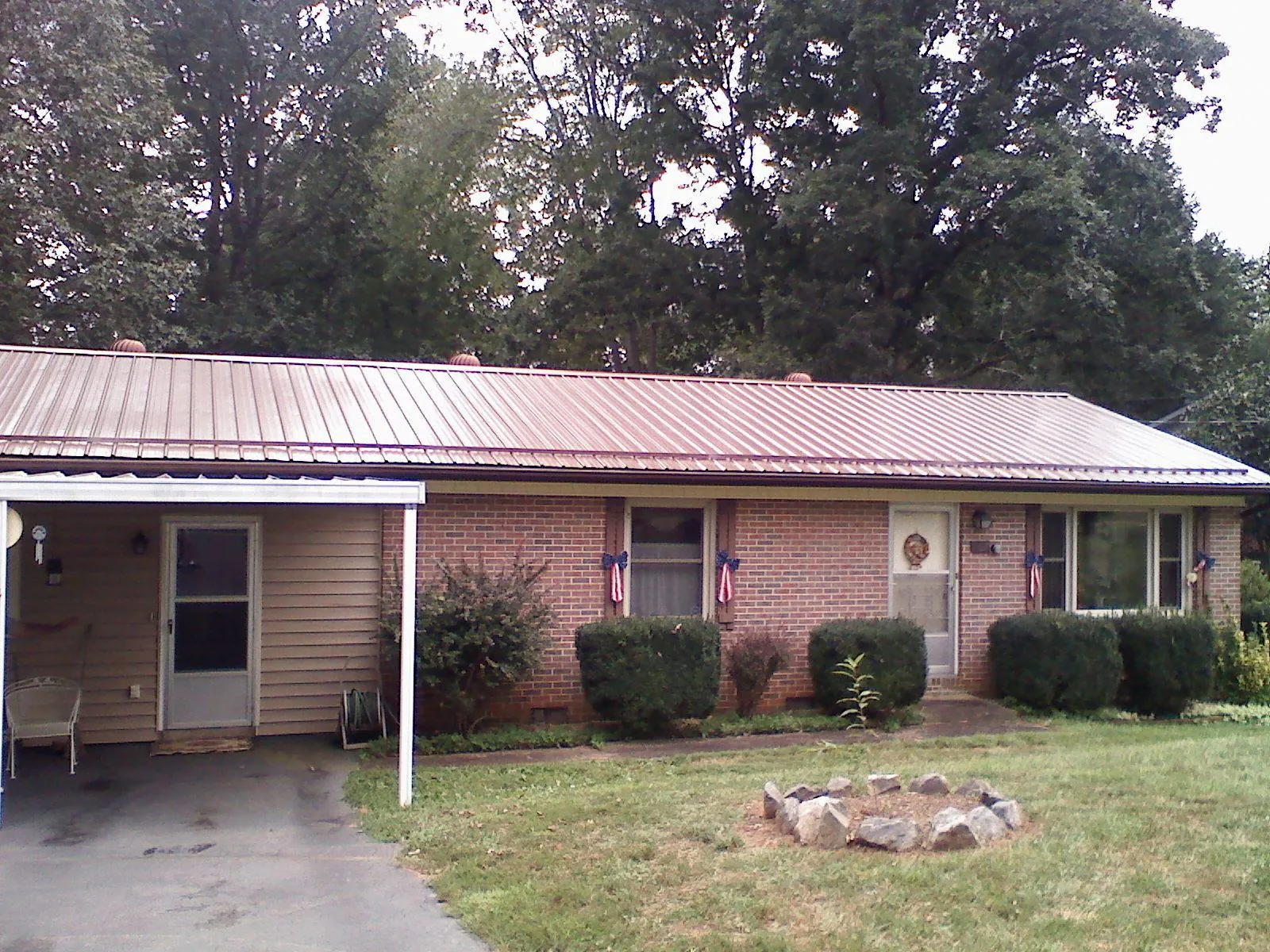 Bronze metal roof and carport on a brick ranch home — Roof Repair work by our crew in Blenheim